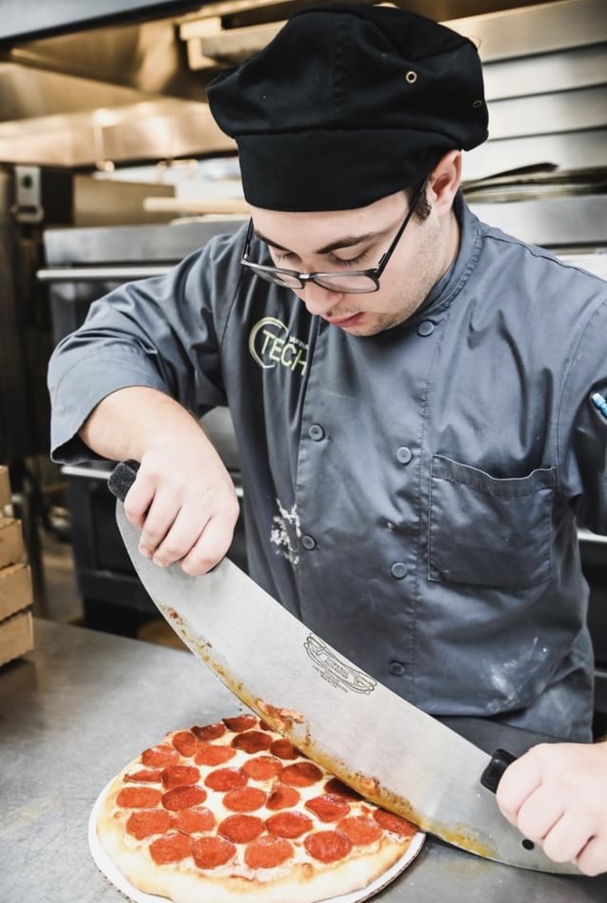 Student Preparing Pizza at VB Tech