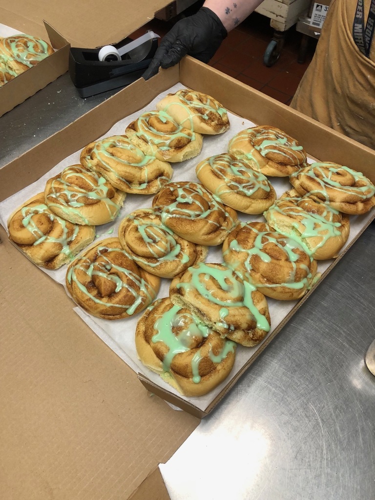 Showing off the green icing for our Cinnamon Rolls
