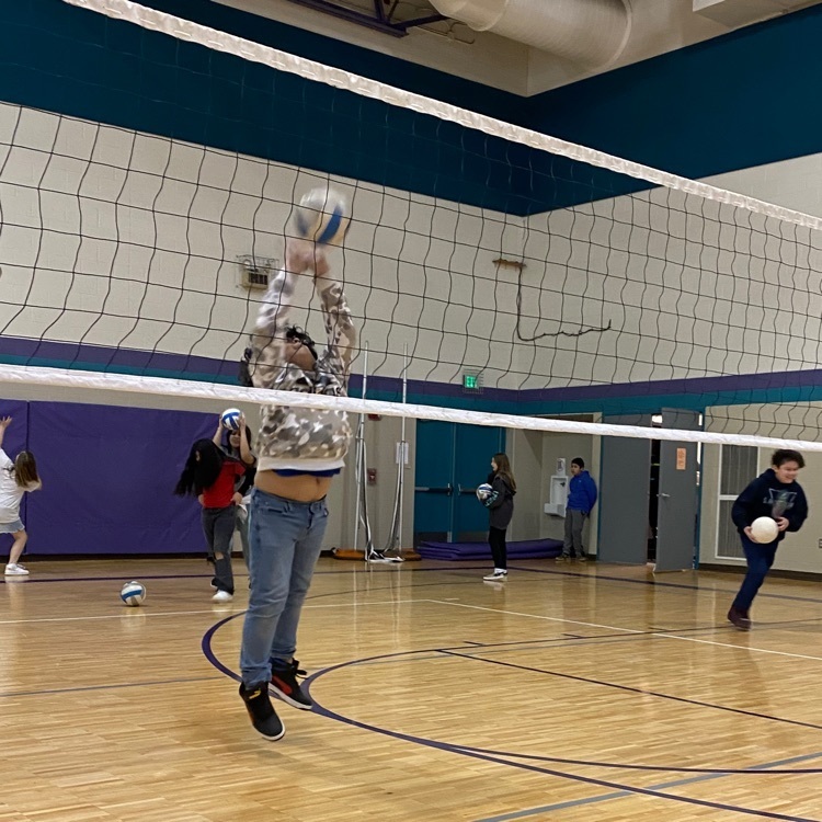 student playing volleyball