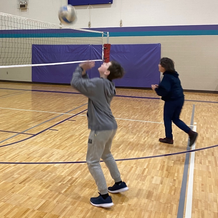 student playing volleyball